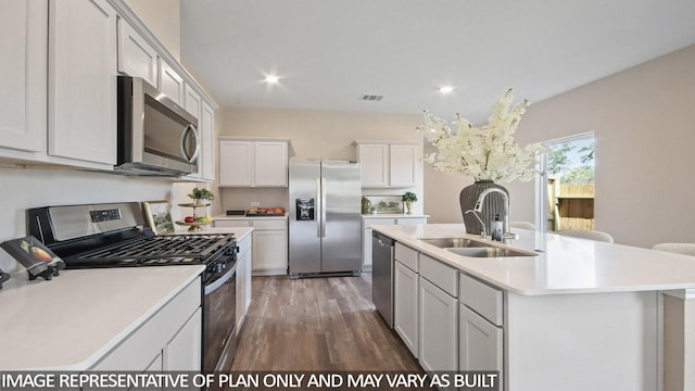 1506 Portia Ct, Conroe, TX 77301 - kitchen featuring appliances with stainless steel finishes, a sink, wood finished floors, light countertops, and an island with sink