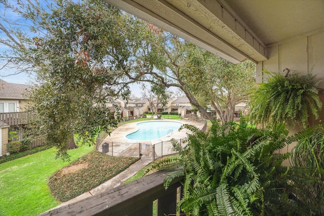 view of swimming pool with fence private yard, a fenced in pool, and a lawn