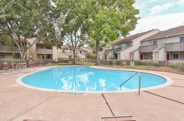 pool with a residential view and fence