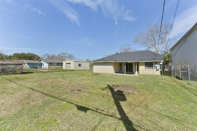 back of property with fence and a yard