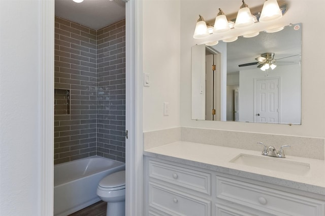 full bath with shower / washtub combination, vanity, toilet, and a ceiling fan