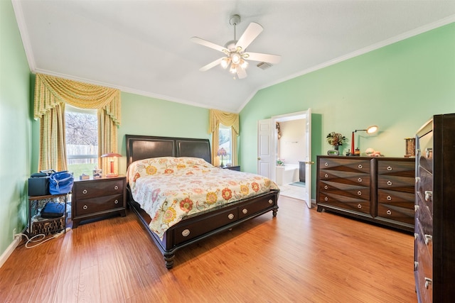 bedroom featuring baseboards, ceiling fan, ornamental molding, vaulted ceiling, and light wood-type flooring