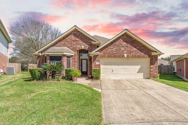 ranch-style home with driveway, a garage, a lawn, fence, and brick siding