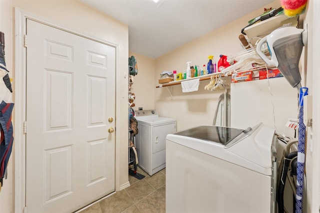 laundry area featuring laundry area, light tile patterned flooring, and separate washer and dryer