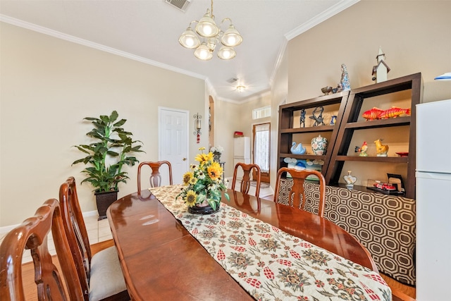 dining area with crown molding and a notable chandelier