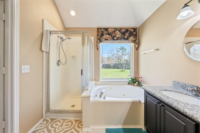 bathroom with a jetted tub, a shower stall, vanity, and tile patterned floors