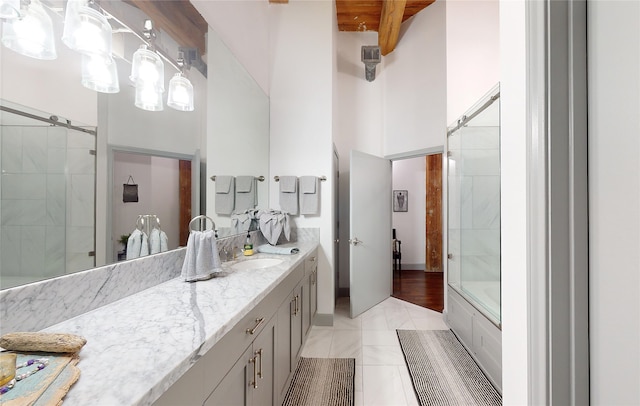 bathroom with beamed ceiling, a shower with shower door, a high ceiling, a bathtub, and vanity