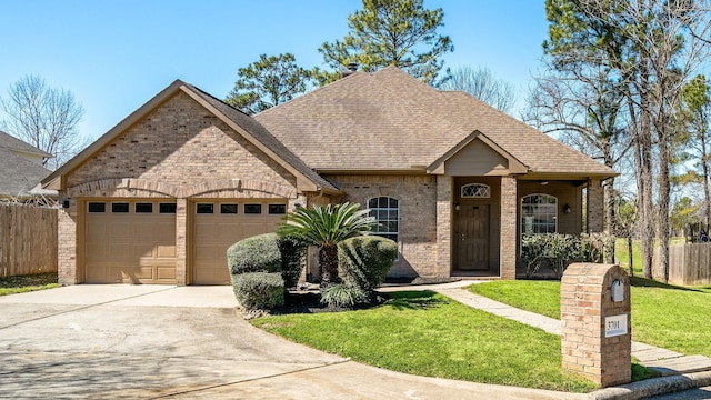 view of front of home featuring a garage, concrete driveway, roof with shingles, fence, and brick siding