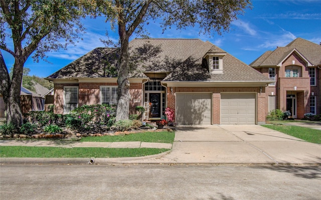 view of front of property featuring an attached garage, concrete driveway, and brick siding