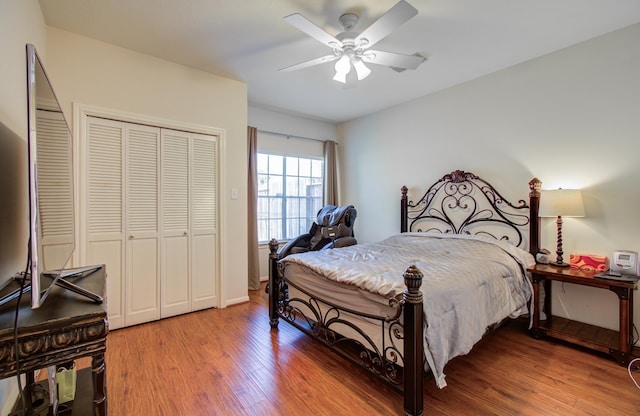 bedroom featuring ceiling fan, a closet, and wood finished floors