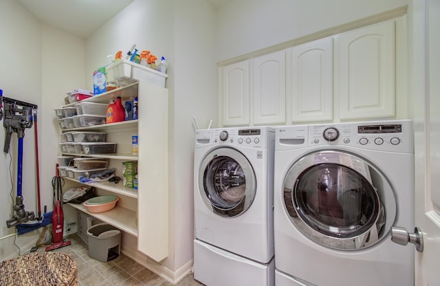 laundry area with washer and dryer, cabinet space, and baseboards