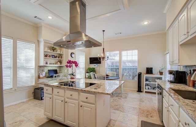 kitchen with island exhaust hood, black electric stovetop, visible vents, decorative backsplash, and ornamental molding