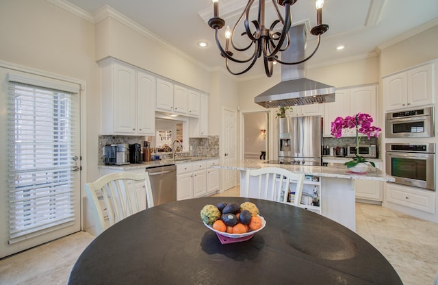 kitchen featuring a chandelier, ornamental molding, stainless steel appliances, white cabinetry, and backsplash