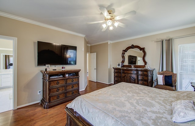 bedroom featuring crown molding, baseboards, and wood finished floors