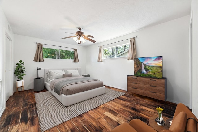 bedroom with ceiling fan, baseboards, and wood finished floors