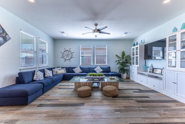 living room with recessed lighting, visible vents, ceiling fan, and wood finished floors