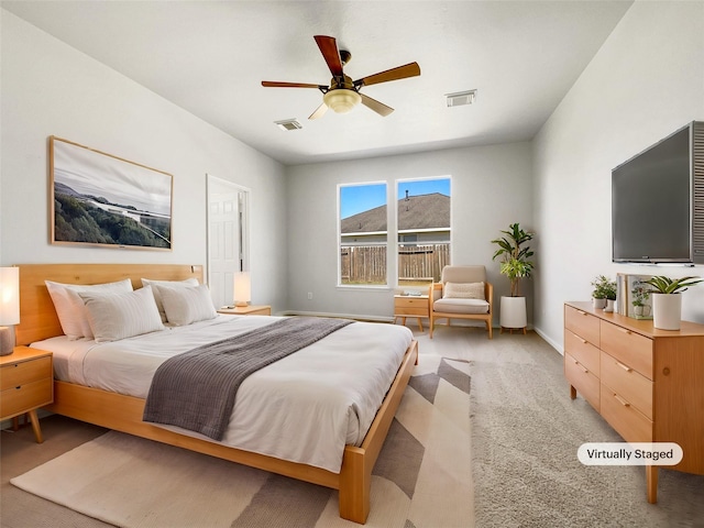 bedroom featuring light carpet, visible vents, baseboards, and ceiling fan