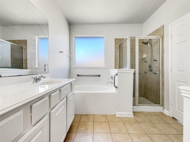 full bath with tile patterned floors, a garden tub, vanity, and a shower stall