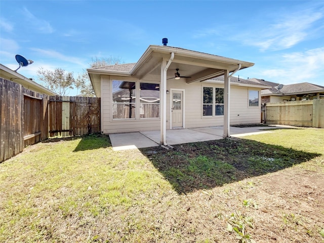 back of property with a yard, a patio, a fenced backyard, and a ceiling fan