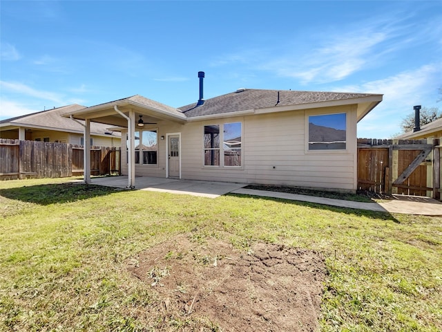 rear view of property with fence, ceiling fan, a lawn, and a patio area