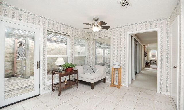 sunroom featuring plenty of natural light, visible vents, and ceiling fan