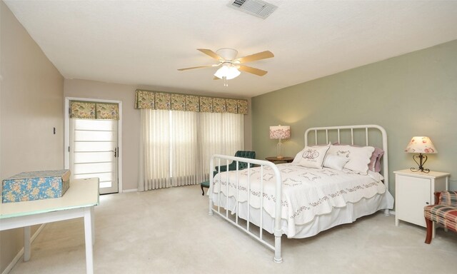 bedroom featuring baseboards, carpet floors, visible vents, and a ceiling fan