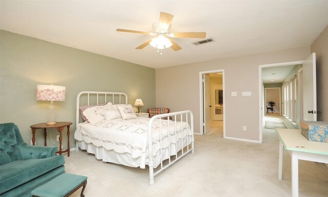 bedroom with baseboards, ceiling fan, visible vents, and light colored carpet