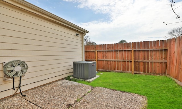 view of yard featuring fence and cooling unit