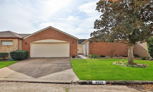 view of front facade with an attached garage, a front yard, concrete driveway, and brick siding