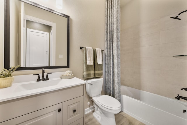 bathroom featuring toilet, shower / bath combo, wood finished floors, and vanity