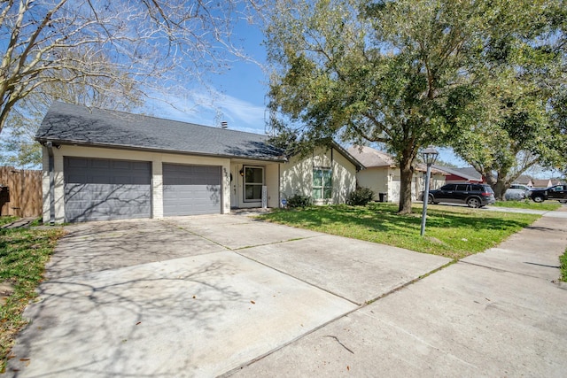 ranch-style home featuring an attached garage, driveway, a front lawn, and fence