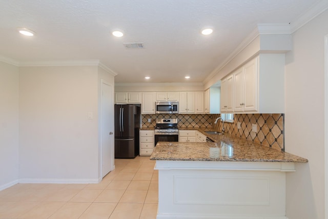 kitchen with crown molding, visible vents, appliances with stainless steel finishes, light stone countertops, and a peninsula