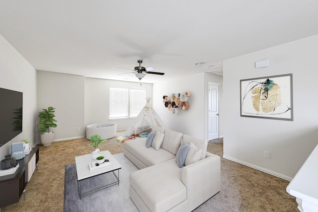 living area featuring a ceiling fan, baseboards, and carpet flooring