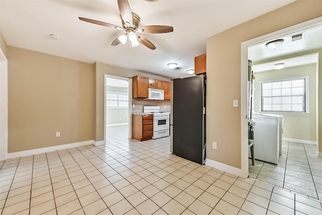 kitchen featuring white appliances, ceiling fan, brown cabinets, light countertops, and light tile patterned flooring