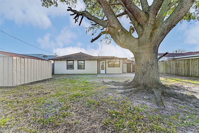 back of house with fence and a patio