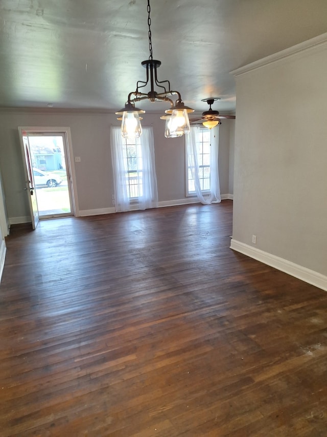 interior space with baseboards, dark wood-style floors, and crown molding