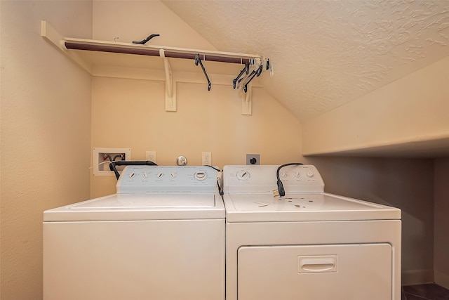 laundry room featuring washer and dryer, laundry area, and a textured ceiling