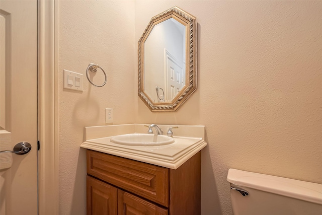 bathroom with toilet and vanity