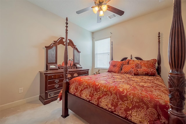 bedroom featuring visible vents, light colored carpet, baseboards, and ceiling fan