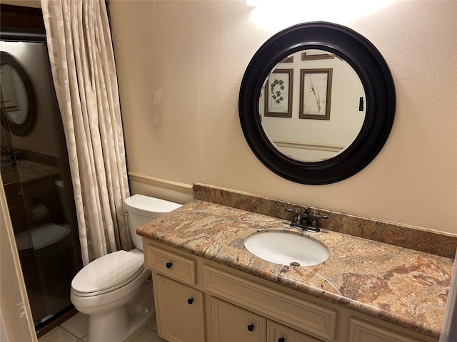 full bath with a stall shower, vanity, toilet, and tile patterned floors