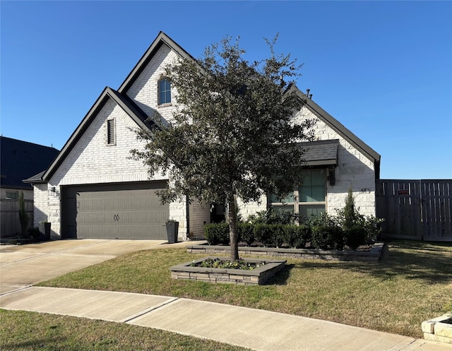 view of front of house featuring a front yard, concrete driveway, brick siding, and fence