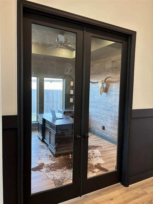 doorway to outside with french doors and wood finished floors