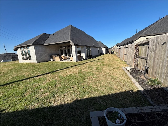 view of yard with outdoor lounge area, a patio area, and a fenced backyard