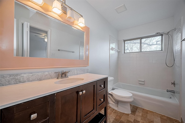 full bath with visible vents, toilet, vanity, and bathtub / shower combination