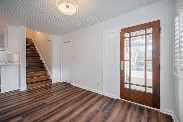 entrance foyer featuring dark wood-style floors, stairs, and crown molding