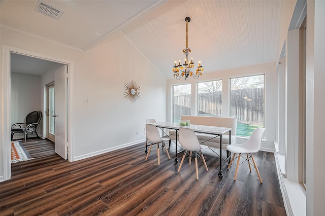 dining room featuring dark wood finished floors, vaulted ceiling, visible vents, and a chandelier