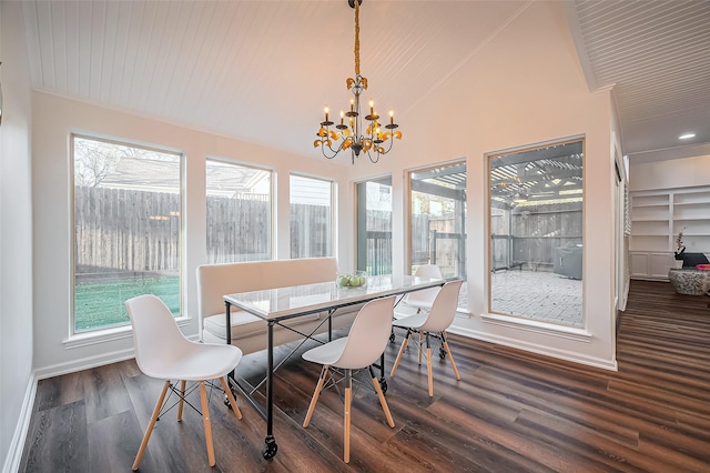 dining area with plenty of natural light, an inviting chandelier, dark wood finished floors, and vaulted ceiling