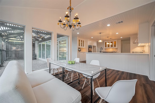 dining room with visible vents, ornamental molding, recessed lighting, an inviting chandelier, and wood finished floors