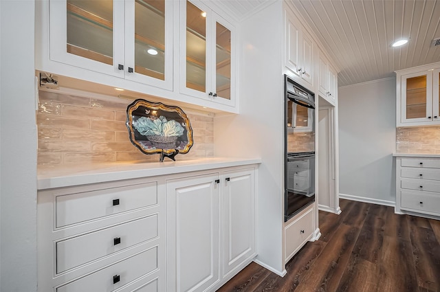 kitchen featuring white cabinets, ornamental molding, and light countertops