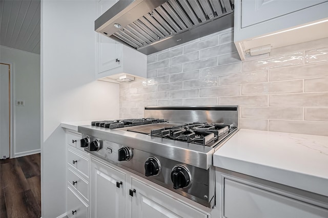 kitchen featuring stainless steel gas cooktop, decorative backsplash, light countertops, and premium range hood